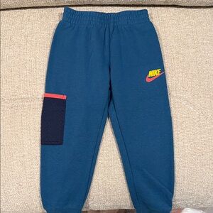 Nike Kids Teal Joggers with Navy Pocket and Neon Logo